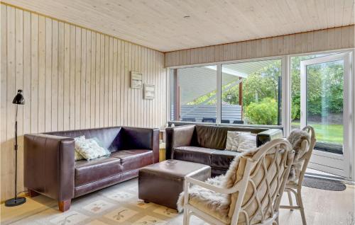 a living room with a couch and a chair at Amazing Home In Skjern With Wifi in Skjern
