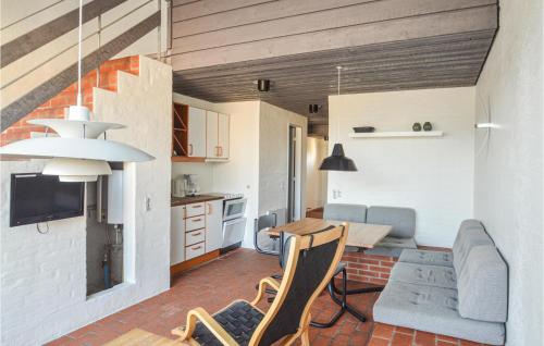 a kitchen and living room with a couch and a table at Feriehotal Tranum Klit in Brovst
