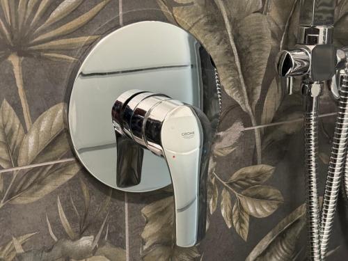 a hair dryer on a wall in front of a mirror at Montecristo B&B in Grosseto