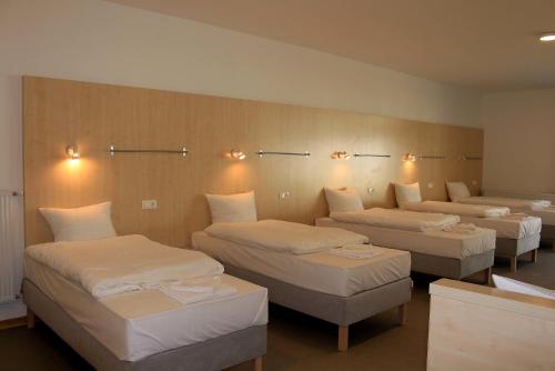 A bed or beds in a room at Szentkút Pilgrim Center