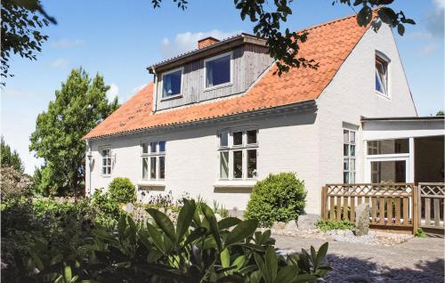 a white house with an orange roof at Two-Bedroom Holiday Home Thyholm With Sea View 04 in Thyholm