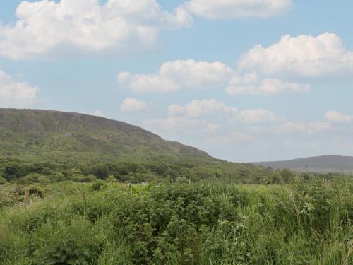 a field of grass with mountains in the background at Mountain View in Limavady