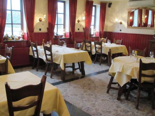 a restaurant with tables and chairs with yellow table cloth at Hotel Restaurant in den Hoof in Maastricht