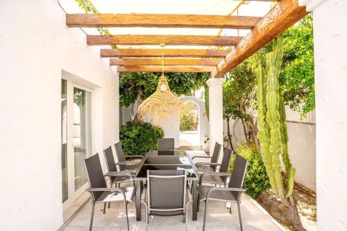 a patio with chairs and a wooden pergola at Residencial Bogamarí in San Antonio Bay
