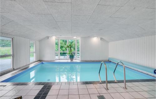 a large swimming pool with a ceiling at Gorgeous Home In Oksbøl With Sauna in Oksbøl