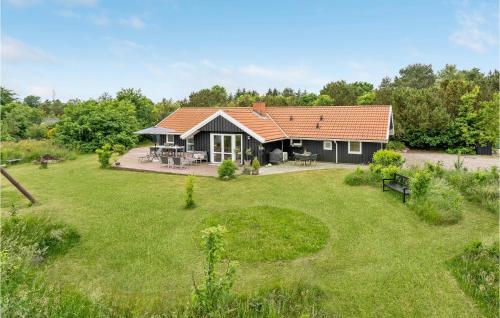 a house with a large yard with a grassy area at Gorgeous Home In Oksbøl With Sauna in Oksbøl