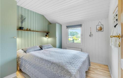 a bedroom with a bed and a window at Gorgeous Home In Oksbøl With Sauna in Oksbøl