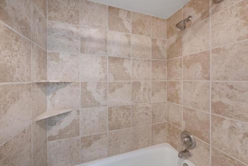 a bathroom with a shower with a white tub at Ski Vista Chic Condo Near the Canyons Slopes in Park City