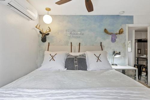 a bedroom with a white bed with antlers on the wall at Megans Mystique 1BR Hidden Creek Condo in Park City