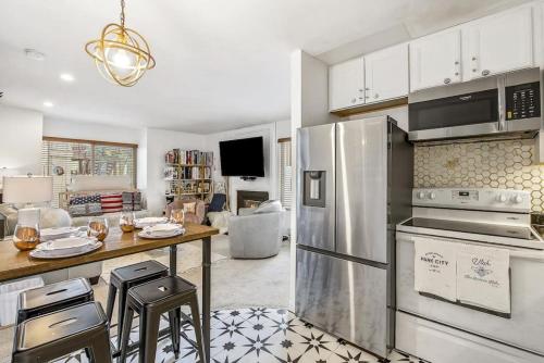 a kitchen with stainless steel appliances and a living room at Megans Mystique 1BR Hidden Creek Condo in Park City