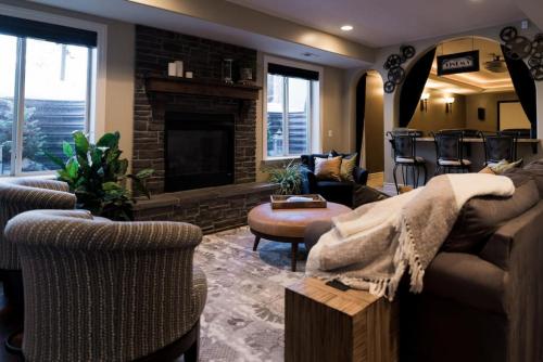 a living room with a couch and a fireplace at Snuggle Down Inn 1BR In Law Basement Suite in Heber City