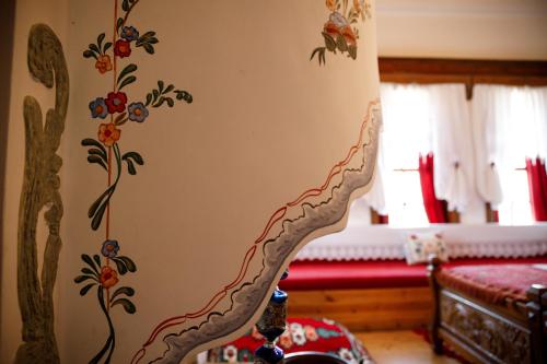 a stairway in a room with flowers on the wall at Boutique Hotel Musée in Gjirokastër