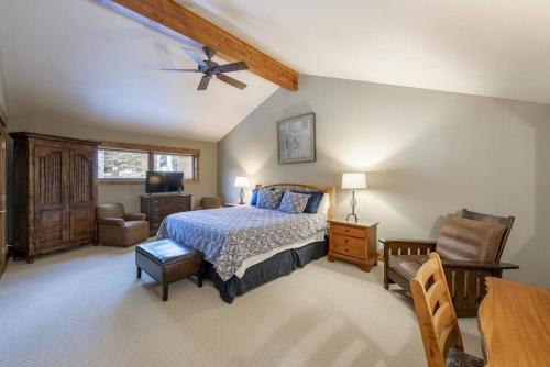 a bedroom with a bed and a chair and a table at Rustic Elegance Located near PCM with Hot Tub in Park City