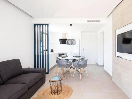 a living room with a couch and a table and chairs at Residencial Bogamarí in San Antonio Bay