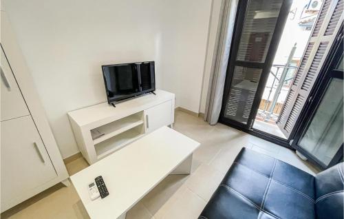 A television and/or entertainment centre at Cozy Apartment In Estepona With Wifi