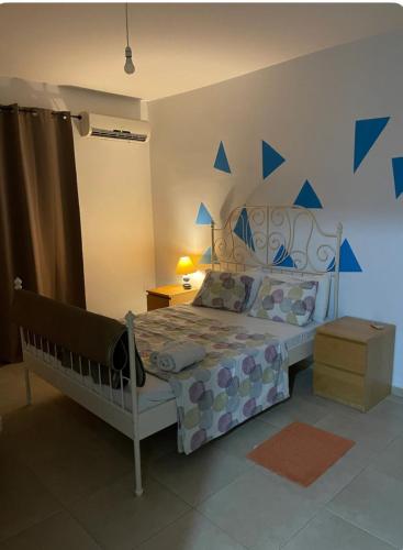 a bedroom with a bed with blue stars on the wall at Tranquil Country Condo - Tersefanou in Larnaca