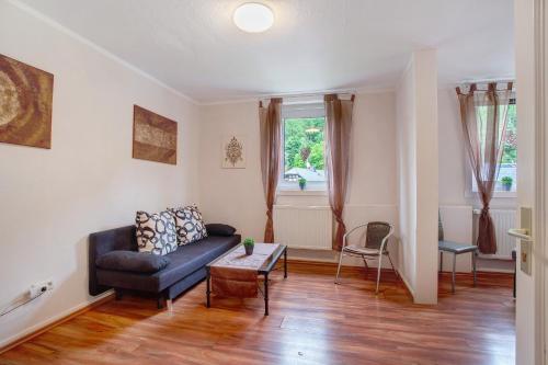 a living room with a couch and a table at Ferienwohnungen Roth in Willingen