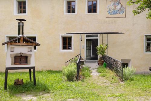 a building with a bird house in front of it at Ansitz Baumannhof Apt Gotik in Falzes