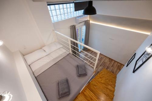 a small room with a couch and a window at Andriotti Loft Aigio in Aígio
