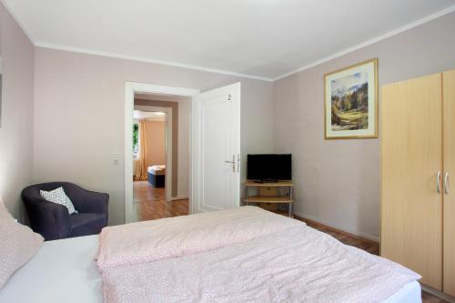 a bedroom with a bed and a television in it at Ferienwohnungen Roth in Willingen