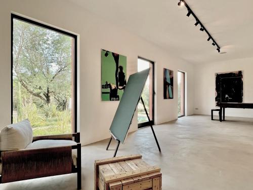 a large white room with a couch and a chair at Toile Blanche in Saint-Paul-de-Vence