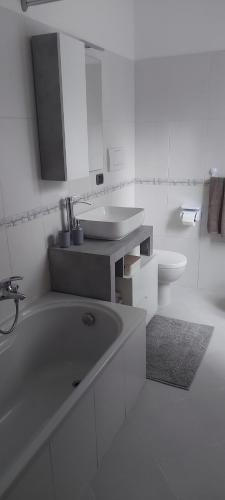 a bathroom with a tub and a sink and a toilet at La Curta di Vegèss in Pregnana Milanese