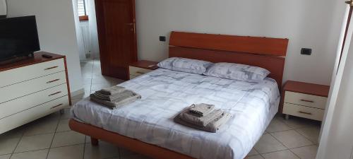 a bedroom with a bed with two towels on it at La Curta di Vegèss in Pregnana Milanese