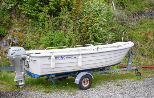 a white boat on a trailer on the grass at Stunning Home In Seim With Wifi in Seim