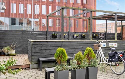 a bike parked in front of a greenhouse with potted plants at 12 Bedroom Gorgeous Home In Kolding in Kolding