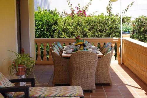 a table and chairs on a balcony with a table and chairs at Villa Sol de Mallorca in Sol de Mallorca