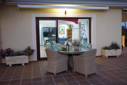 a dining table and chairs in a room with a table at Villa Sol de Mallorca in Sol de Mallorca