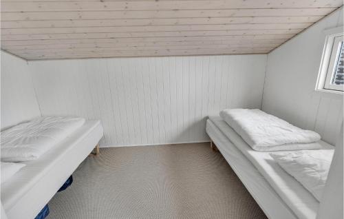 two beds in a small room with a window at Stunning Home In Randers Nø With Wifi in Skalmstrup