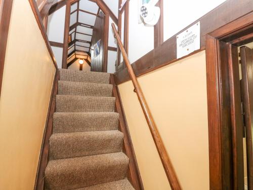 a staircase in a building with a stair case at Loanview in Cornhill-on-tweed