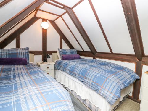a room with two beds in a attic at Loanview in Cornhill-on-tweed