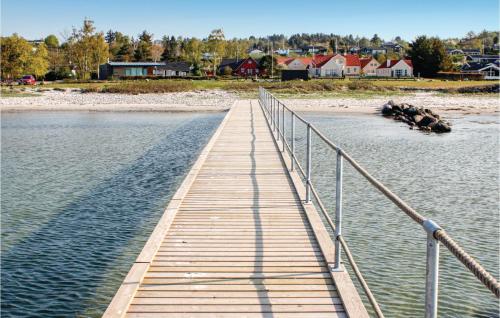 a wooden bridge over a body of water at Nice Home In Ebeltoft With Kitchen in Ebeltoft