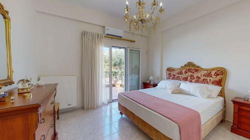 a bedroom with a bed and a dresser and a mirror at Villa Manetti with Private Pool and Garden by Hospi in Kokkíni Khánion