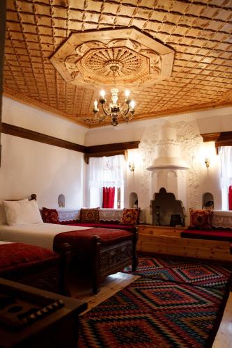 a bedroom with a bed and a chandelier at Boutique Hotel Musée in Gjirokastër