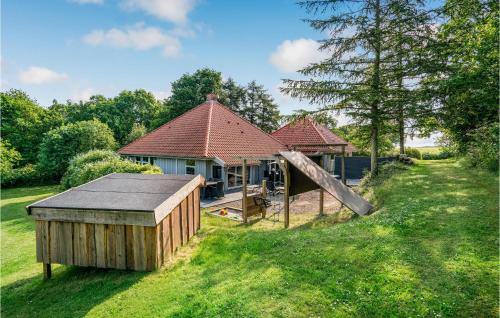 a house with a play structure in the yard at Cozy Home In Asperup With Sauna in Asperup