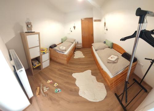 a small room with two beds and a mirror at Am-Christophorus Mölltaler Gletscher in Flattach