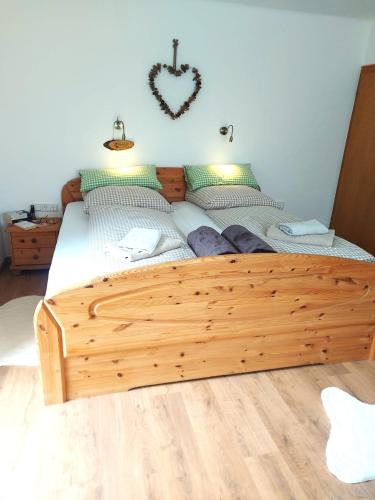 a wooden bed with a wooden frame in a bedroom at Am-Christophorus Mölltaler Gletscher in Flattach
