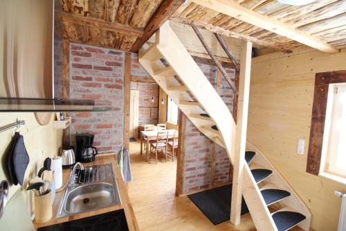 a staircase in a tiny home with a brick wall at Ferienhaus Anno Dazumal wie zu Großmutters Zeiten, Gösselberg 24 in Klingenthal