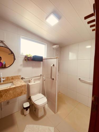 a bathroom with a toilet and a sink and a shower at Pontal dos Sonhos- Chalés Praia do Farol in Coruripe