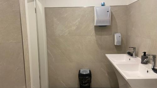 a small bathroom with a sink and a shower at Hotel Business Bay das ehemalige Staycation Hotel in Sindelfingen
