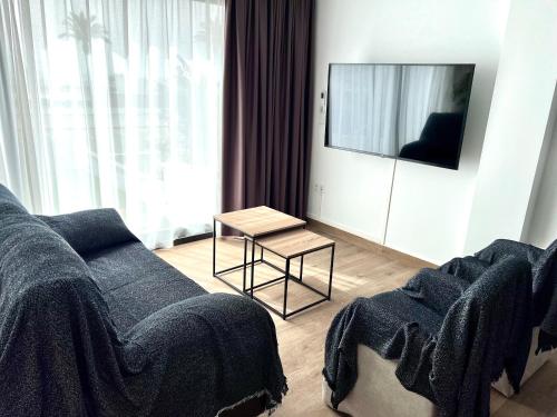 a living room with a couch and a table at Casa LARA in Empuriabrava