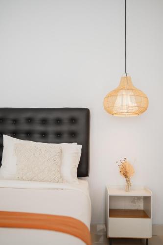 a bedroom with a bed and a lamp and a table at Gisela Villa With Private Pool in Buleleng