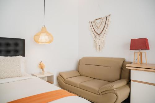 a bedroom with a bed and a chair in it at Gisela Villa With Private Pool in Buleleng