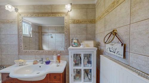 a bathroom with a sink and a mirror and a tub at Villa Manetti with Private Pool and Garden by Hospi in Kokkíni Khánion