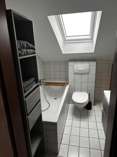 a bathroom with a sink and a toilet with a skylight at KRAICHGAU # 3-ZKB mit Balkon und Klimaanlage, Monteurzimmer in Kirchardt