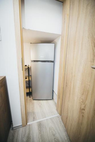 a white refrigerator in a room with a hallway at Kuća za odmor Suha gora in Vrhovac