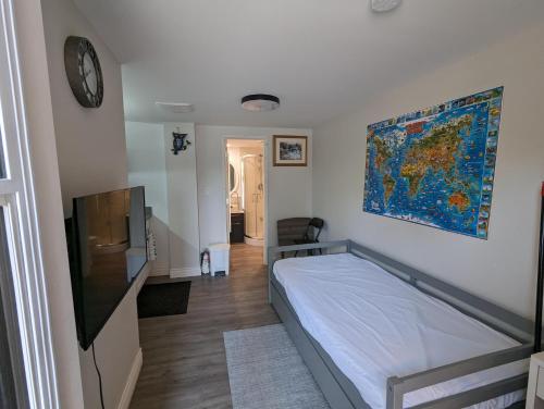 a bedroom with a bed and a clock on the wall at Modern Tiny Wood Cottage 0 in Wasaga Beach
